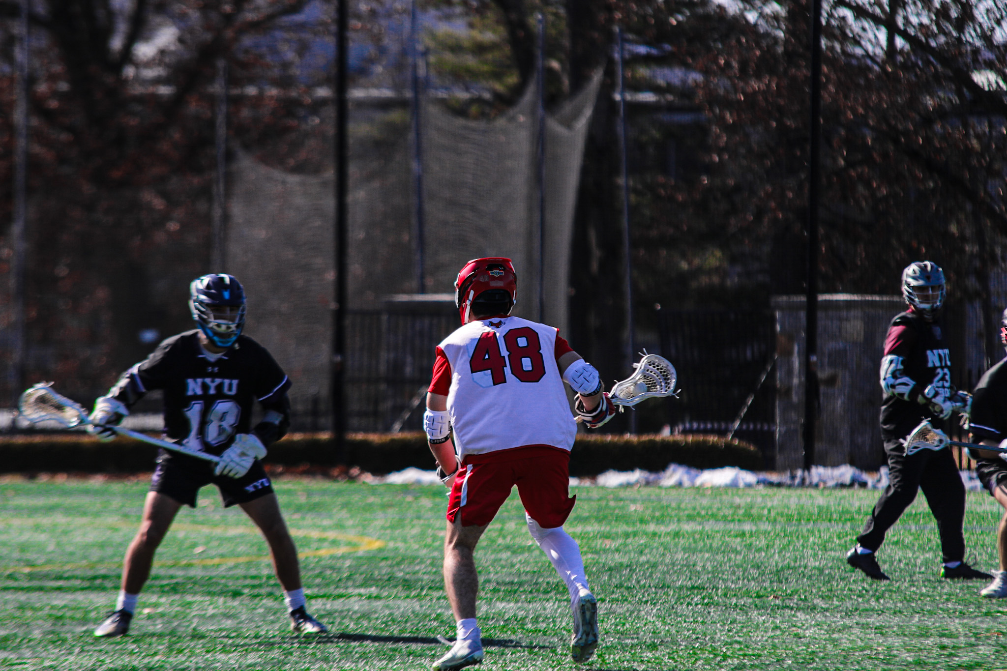 Live game action during NYU lacrosse match
